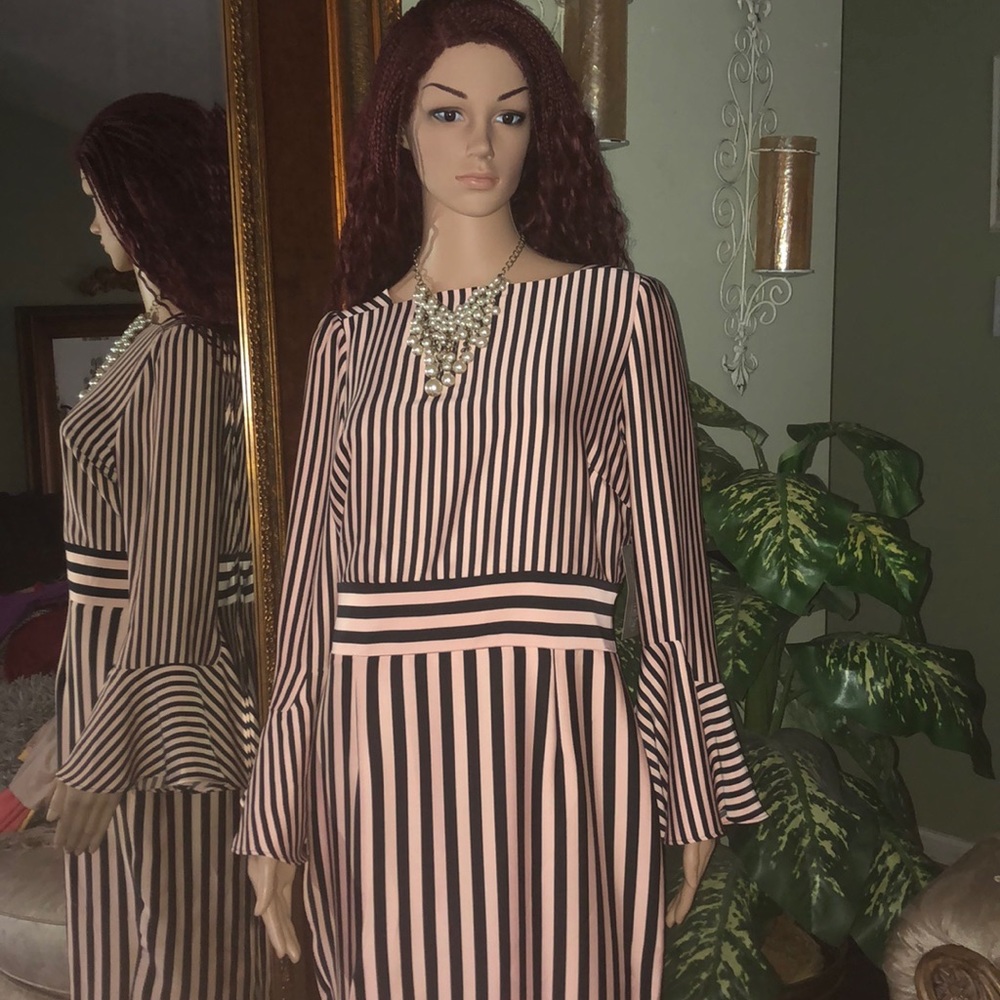 A black and peach dress with bell bottom sleeves.